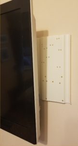 Plastic mounting board behind TV